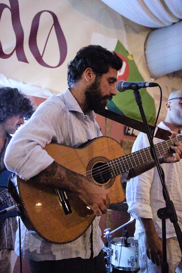 Musician playing guitar live in the marquee
