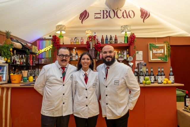Bar team in white jackets in front of the bar