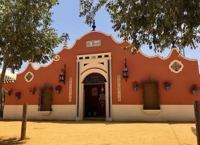 Front of the El Bocao caseta at the fairground by day: terracotta façade with blue tiles and the “El Bocao” sign