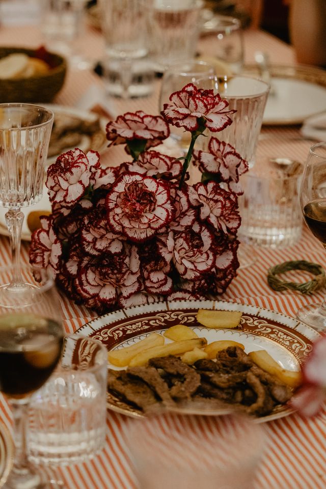 Carnation centrepiece beside a plate