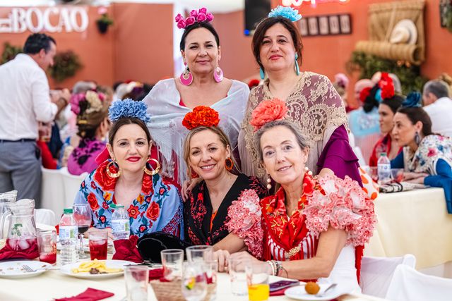 Table of friends in flamenco dresses in the caseta