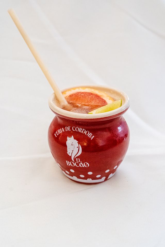 Clay cup with a Paloma cocktail and the “El Bocao” print